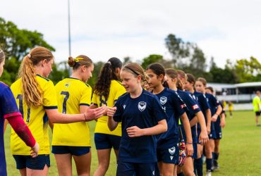 Girls teams showing sportsmanship after a junior football game at the Premier Invitational