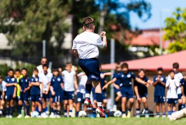 Junior football player celebrating during Mini’s 2025 tournament